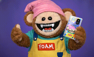 artist foami with a diamond grill holding a Keystone Pro 3 with a custom designed and printed
  walletSkinz made by foami himself 